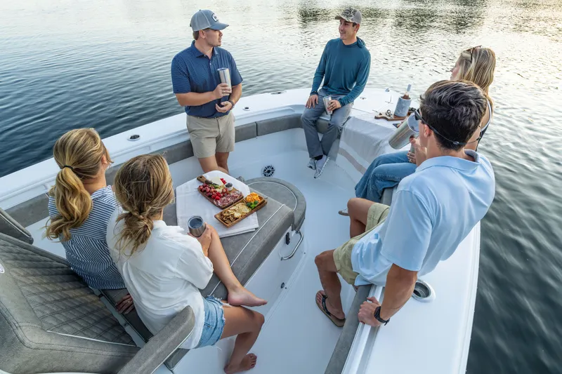 Slide: The Image of Group enjoying a gathering on a 2026 Sea Hunt Ultra 305 Coffin Box boat. - 3