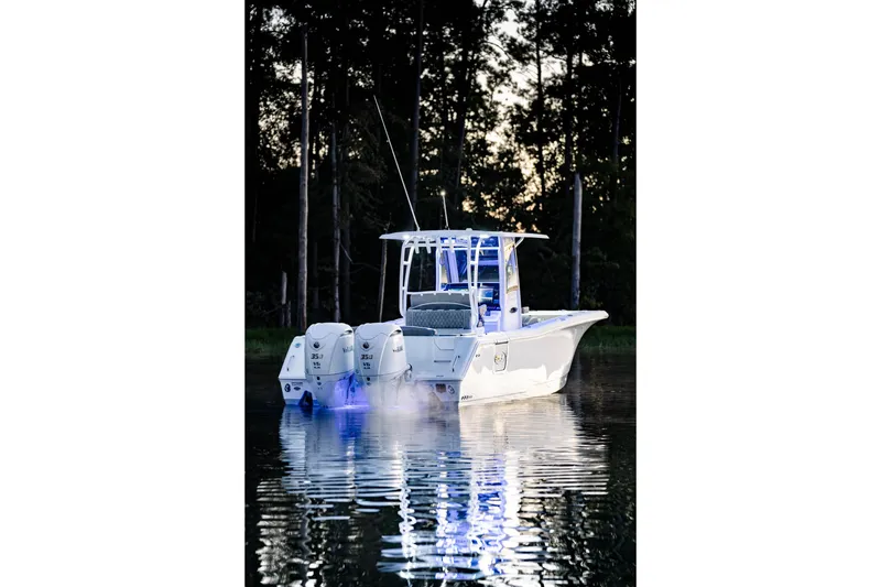 Slide: The Image of 2026 Sea Hunt Ultra 305 Coffin Box boat with dual engines on calm water. - 36