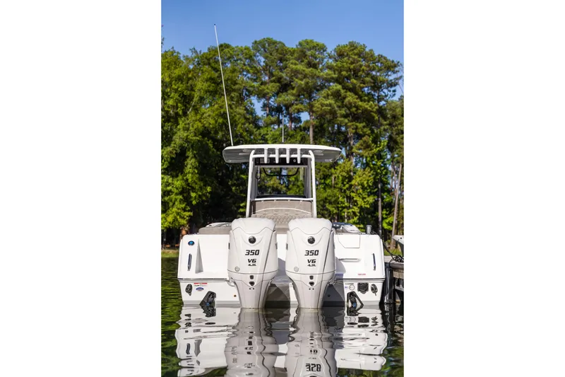 Slide: The Image of Sea Hunt Ultra 305 Coffin Box 2026 boat with dual engines on calm water. - 38