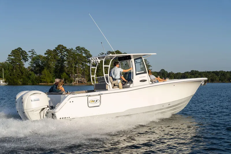 Slide: The Image of 2026 Sea Hunt Ultra 305 Coffin Box boat cruising on a serene lake. - 5