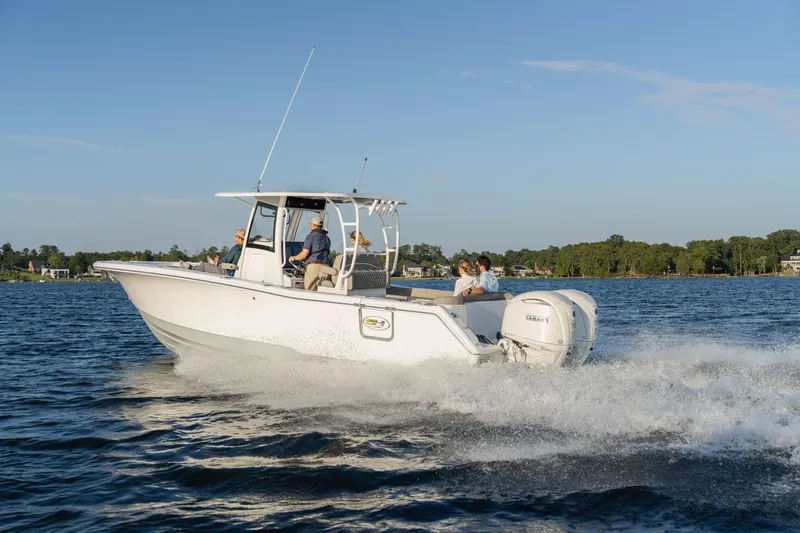 Slide: The Image of 2026 Sea Hunt Ultra 305 Coffin Box boat cruising on a sunny lake. - 7