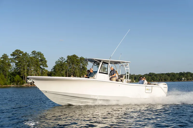 Slide: The Image of 2026 Sea Hunt Ultra 305 Coffin Box boat cruising on a serene lake. - 8