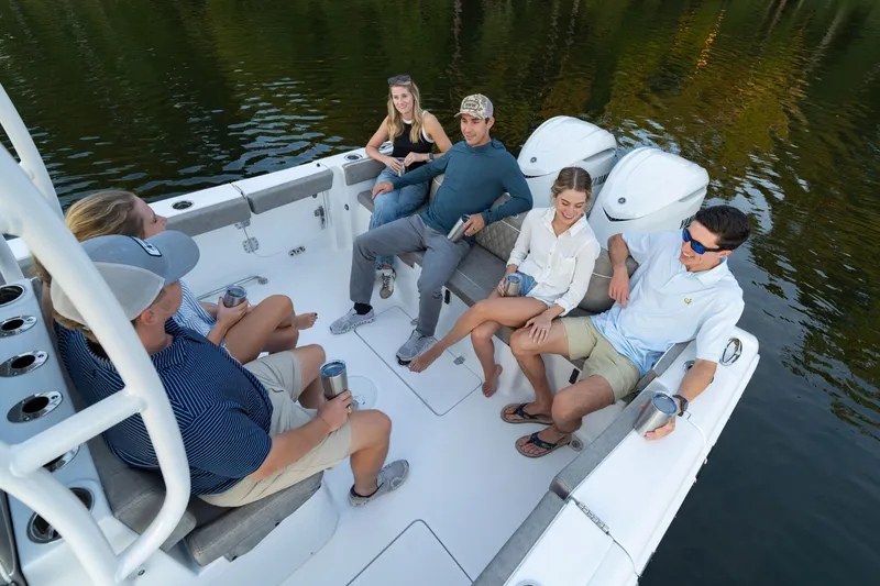 Slide: The Image of Group enjoying on a 2026 Sea Hunt Ultra 305 Coffin Box boat, surrounded by water. - 9
