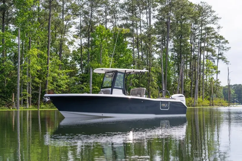 Slide: The Image of 2026 Sea Hunt Ultra 255 SE boat storage compartments open, showcasing interior features. - 10