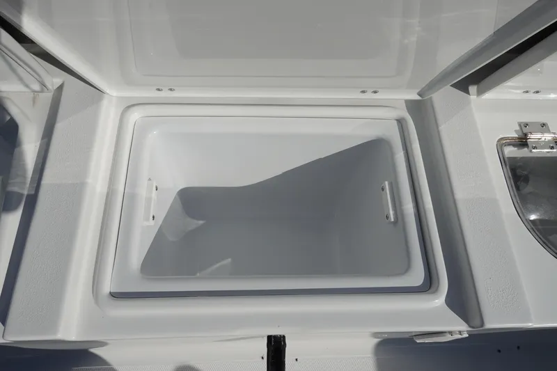 Slide: The Image of Open storage compartment on 2026 Sea Hunt Ultra 255 SE boat. - 12