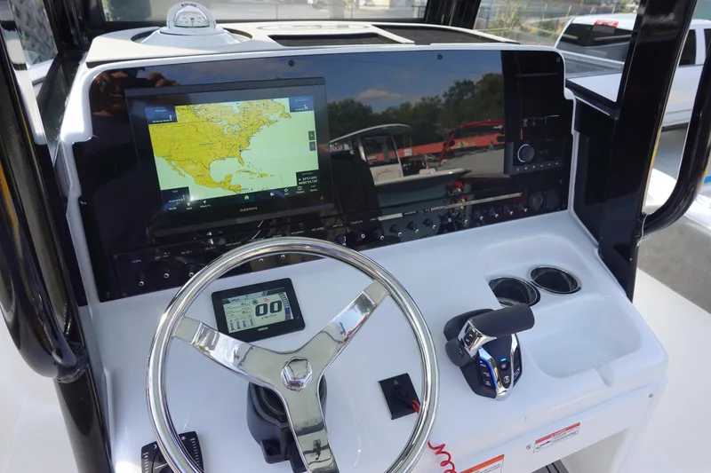 Slide: The Image of 2026 Sea Hunt Ultra 255 SE boat dashboard with navigation display and controls. - 23