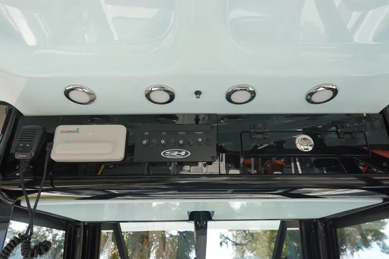 Slide: The Image of 2026 Sea Hunt Ultra 255 SE dashboard with Garmin equipment and controls. - 26