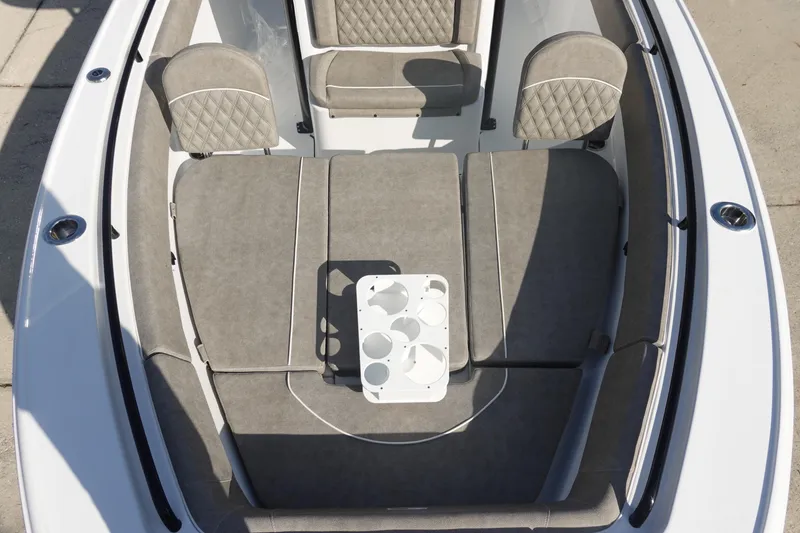 Slide: The Image of 2026 Sea Hunt Ultra 255 SE boat interior with cushioned seating and cup holders. - 31