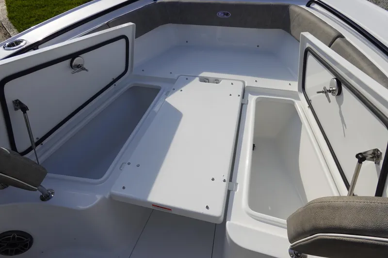 Slide: The Image of 2026 Sea Hunt Ultra 255 SE boat with open storage compartments. - 33