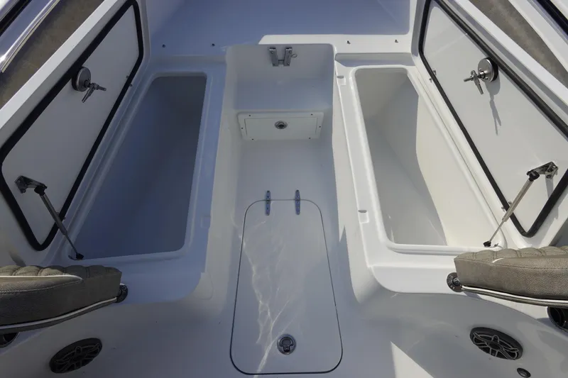 Slide: The Image of 2026 Sea Hunt Ultra 255 SE boat storage compartments and seating area. - 34
