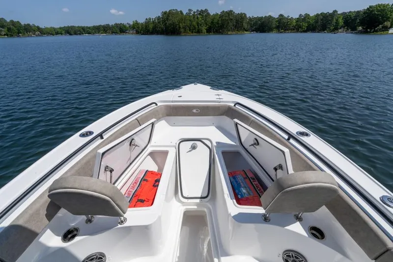 Slide: The Image of 2026 Sea Hunt Ultra 255 SE boat interior with cushioned seating and storage compartments. - 9