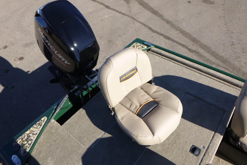 Slide: The Image of 2026 Tracker Bass Tracker Classic Limited boat seat and Mercury engine on deck. - 11