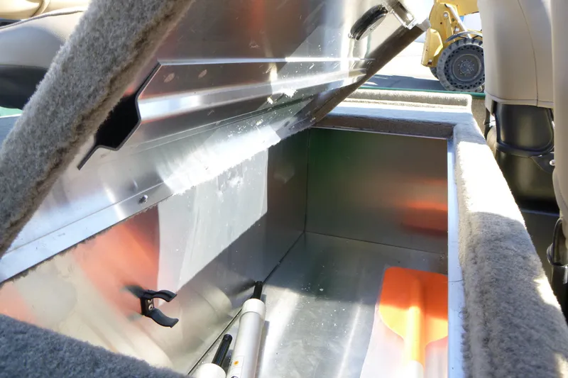 Slide: The Image of 2026 Tracker Bass Tracker Classic Limited storage compartment with open lid, showcasing interior space. - 12