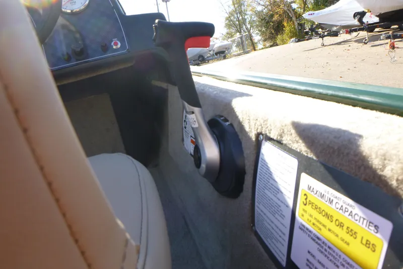 Slide: The Image of Interior of 2026 Tracker Bass Tracker Classic Limited boat with control lever and capacity label. - 17