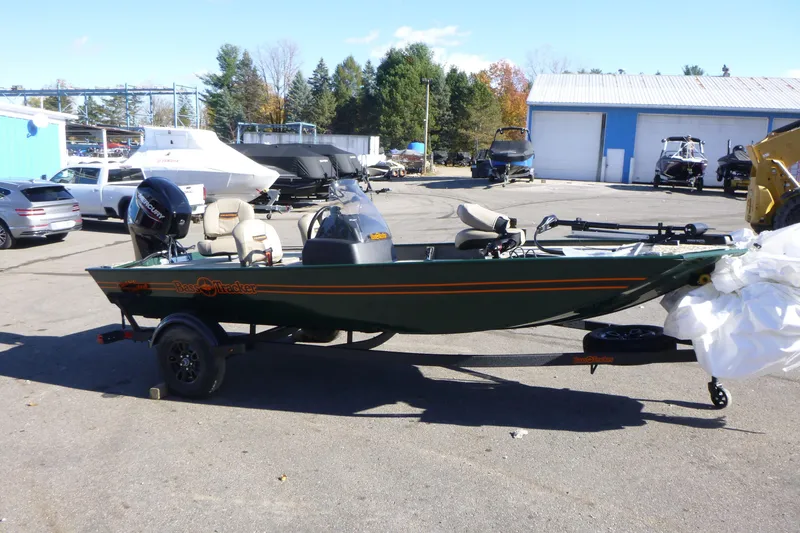 Slide: The Image of 2026 Tracker Bass Tracker Classic Limited boat on trailer in outdoor lot. - 2