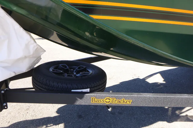 Slide: The Image of 2026 Tracker Bass Tracker Classic Limited boat trailer with spare tire, green and yellow design. - 7