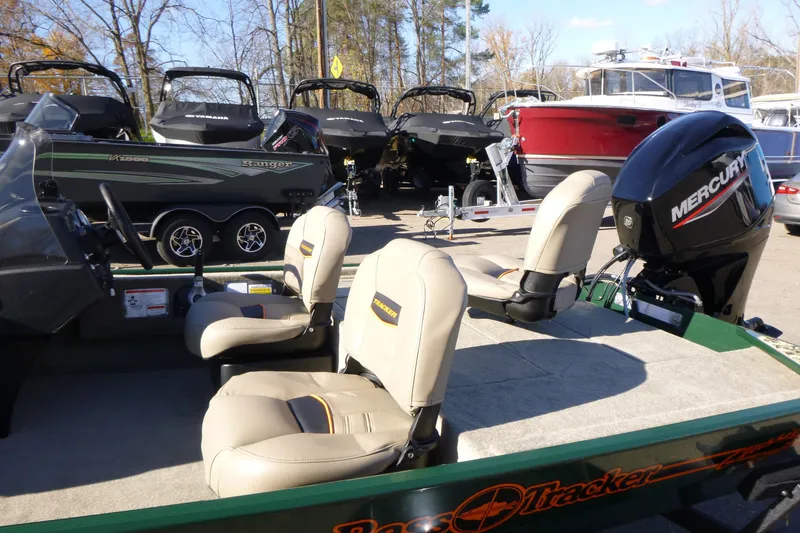 Slide: The Image of 2026 Tracker Bass Tracker Classic Limited boat with Mercury engine, displayed outdoors. - 8