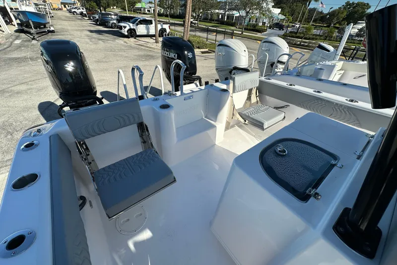 Slide: The Image of 2025 Twin Vee 280 GFX2 CC boat interior with seating and dual Suzuki engines. - 14