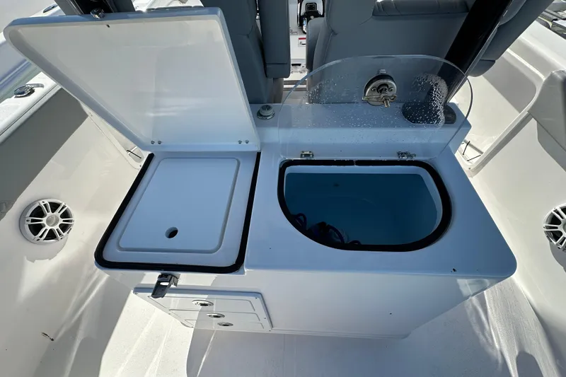 Slide: The Image of 2025 Twin Vee 280 GFX2 CC boat interior with open storage compartments and seating. - 15