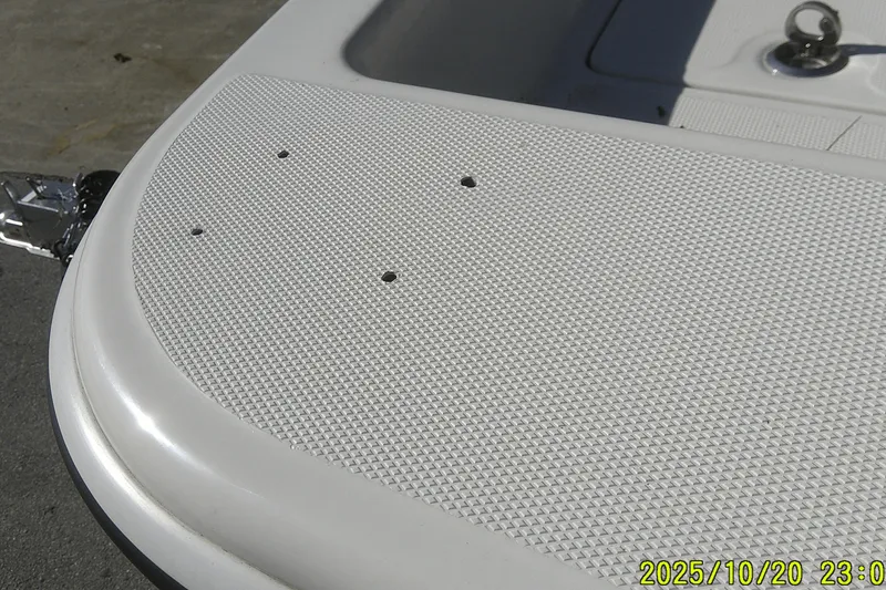 Slide: The Image of Close-up of 2025 Mako Pro Skiff 15 CC boat deck with textured surface. - 2