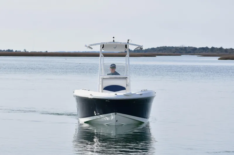 The Image of 2021 Robalo R180 Center Console boat cruising on calm waters. - 0