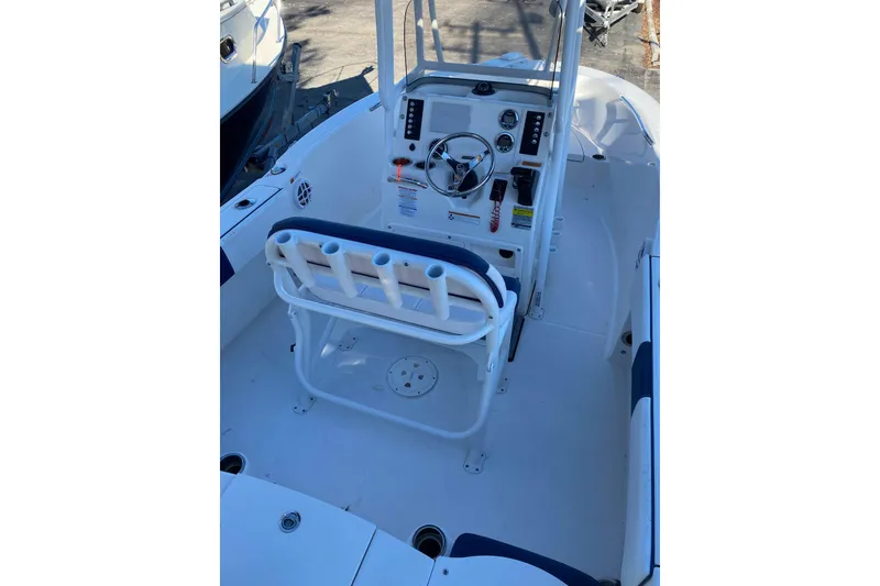 Slide: The Image of 2021 Robalo R180 Center Console boat on calm water with Yamaha engine. - 2