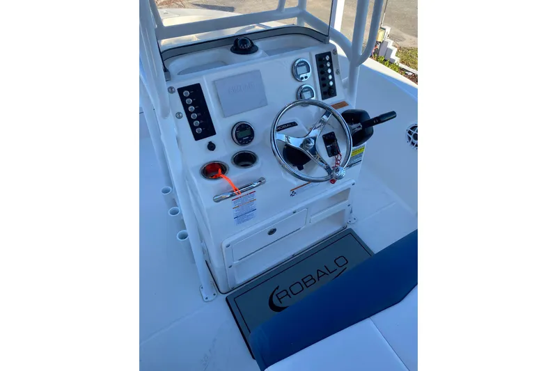 Slide: The Image of 2021 Robalo R180 Center Console boat on calm water, featuring a sleek blue and white design. - 3