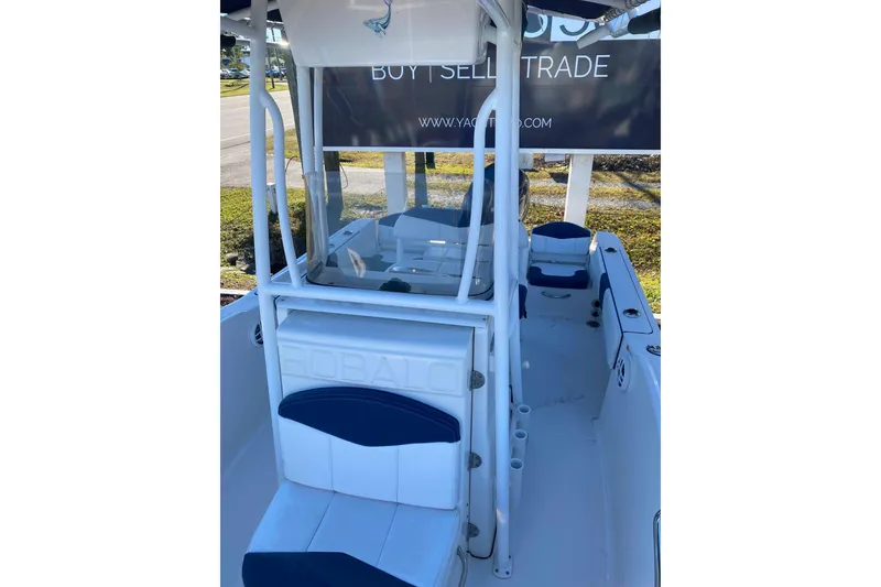 Slide: The Image of 2021 Robalo R180 Center Console boat on calm water, showcasing sleek design. - 5