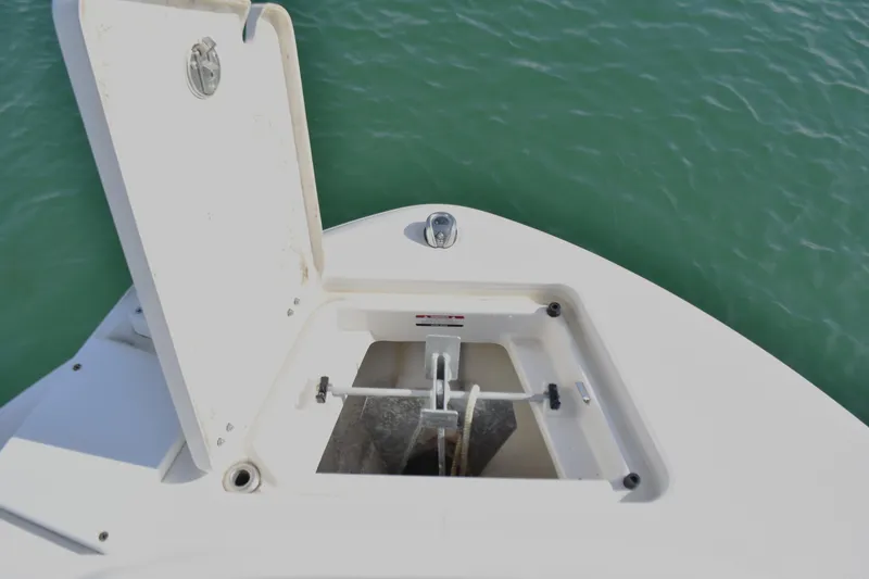 Slide: The Image of 2021 Robalo R180 Center Console anchor compartment open on calm water. - 7