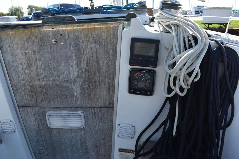 Slide: The Image of 1996 Beneteau Oceanis 321 sailboat cockpit with ropes and navigation instruments. - 21