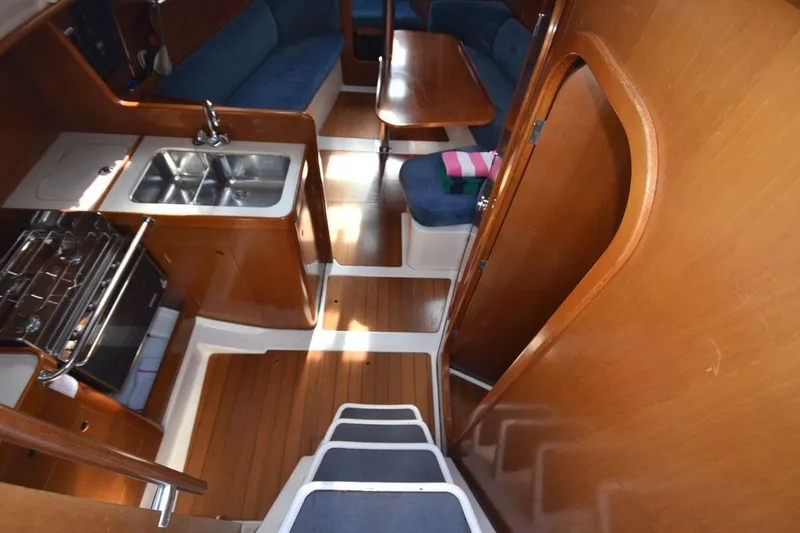 Slide: The Image of Interior of 1996 Beneteau Oceanis 321 sailboat with kitchen and seating area. - 25