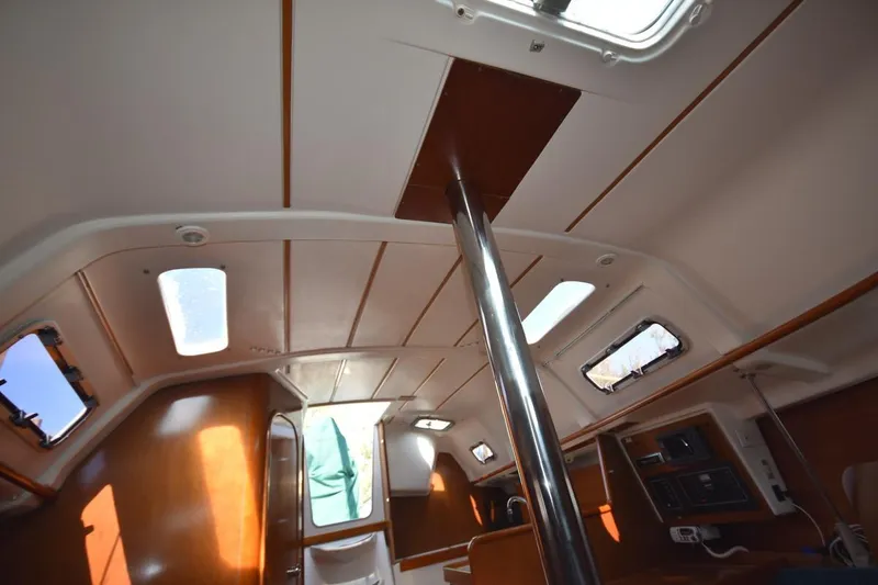 Slide: The Image of Interior view of 1996 Beneteau Oceanis 321 sailboat cabin with wooden finish and windows. - 31