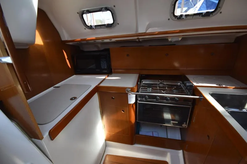 Slide: The Image of Interior of 1996 Beneteau Oceanis 321 yacht kitchen with stove, sink, and microwave. - 36