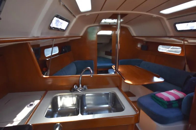 Slide: The Image of Interior of 1996 Beneteau Oceanis 321 sailboat with kitchen and seating area. - 41