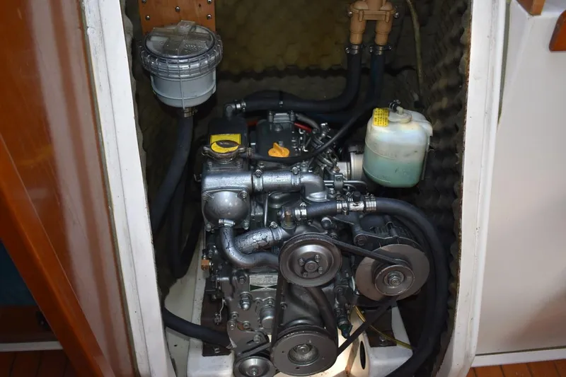 Slide: The Image of Engine compartment of a 1996 Beneteau Oceanis 321 sailboat, showcasing mechanical components. - 44