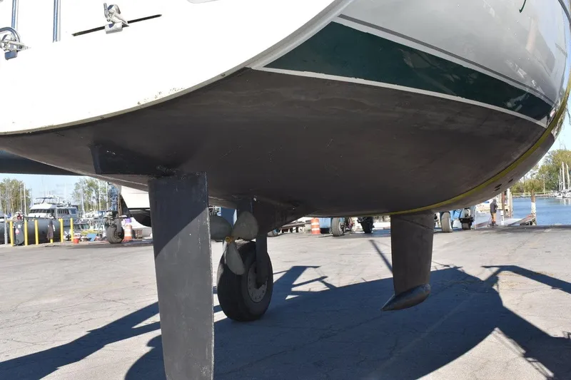 Slide: The Image of 1996 Beneteau Oceanis 321 sailboat on dry dock, showing keel and propeller. - 49