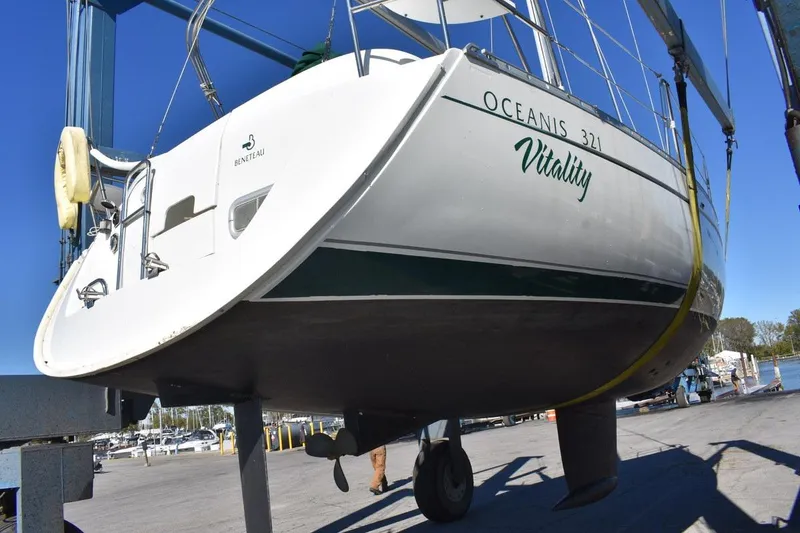 Slide: The Image of 1996 Beneteau Oceanis 321 sailboat named Vitality on a lift at a marina. - 50