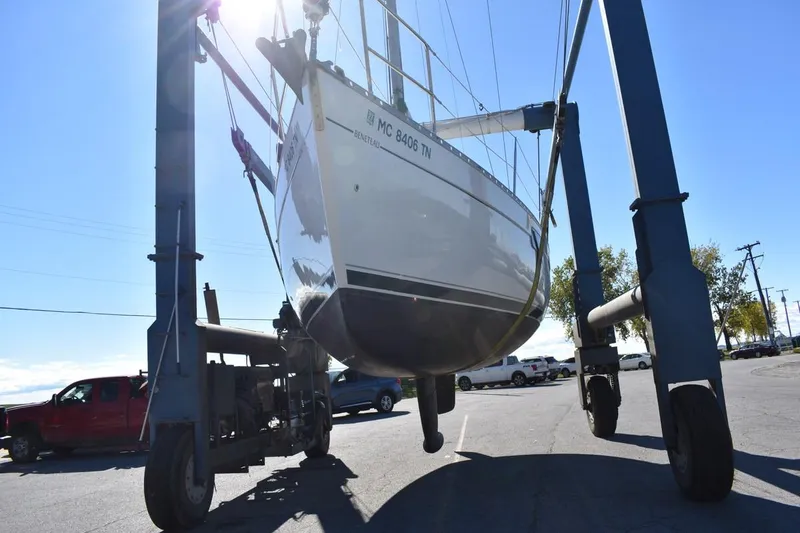 Slide: The Image of Beneteau Oceanis 321 sailboat from 1996 being lifted by a crane. - 52
