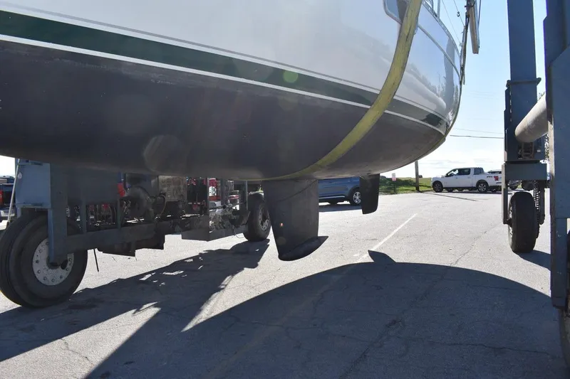 Slide: The Image of 1996 Beneteau Oceanis 321 sailboat on trailer, showing hull and keel. - 53