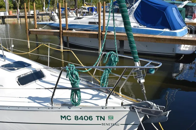Slide: The Image of 1996 Beneteau Oceanis 321 sailboat docked in marina, featuring green ropes and anchor. - 6