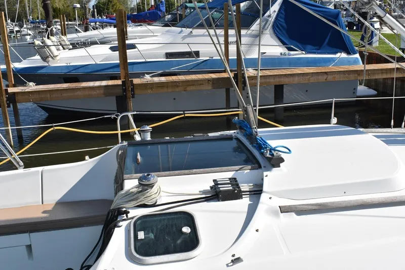Slide: The Image of 1996 Beneteau Oceanis 321 sailboat docked at marina, featuring deck and rigging. - 8