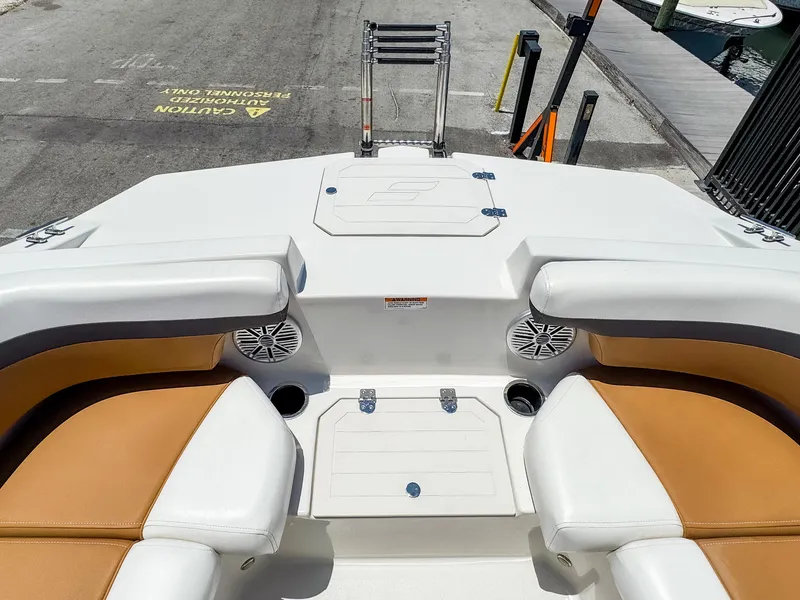 Slide: The Image of 2023 Starcraft SVX 190 OB boat interior with tan and white seating, docked at marina. - 13