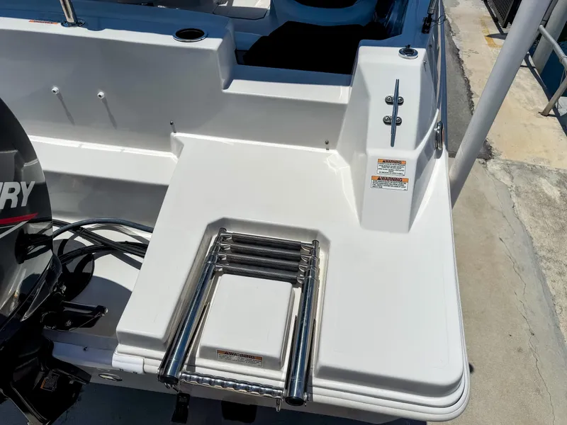 Slide: The Image of 2023 Starcraft SVX 190 OB boat with a foldable swim ladder on the deck. - 4