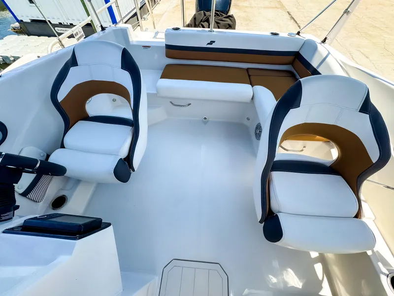 Slide: The Image of 2023 Starcraft SVX 190 OB boat interior with white and brown seating arrangement. - 5