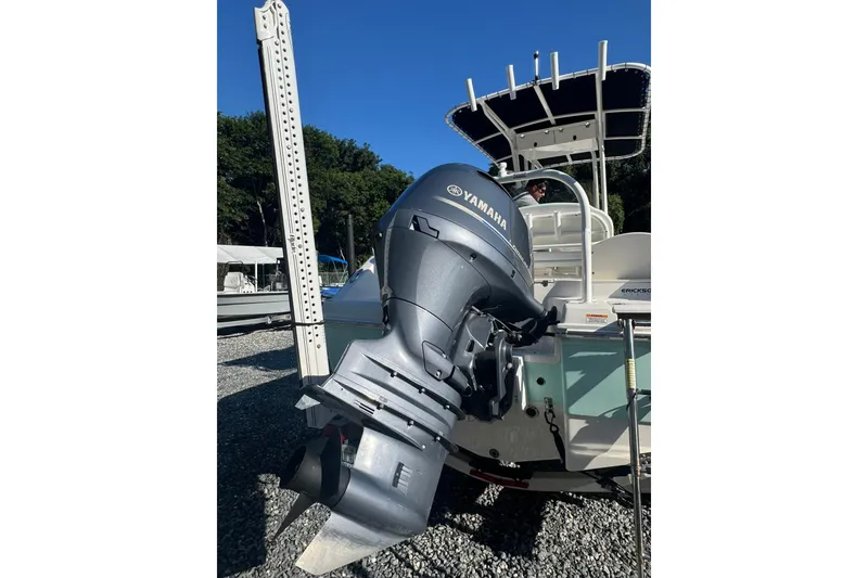 Slide: The Image of 2021 Robalo R200 Center Console with Yamaha outboard motor, parked outdoors. - 2