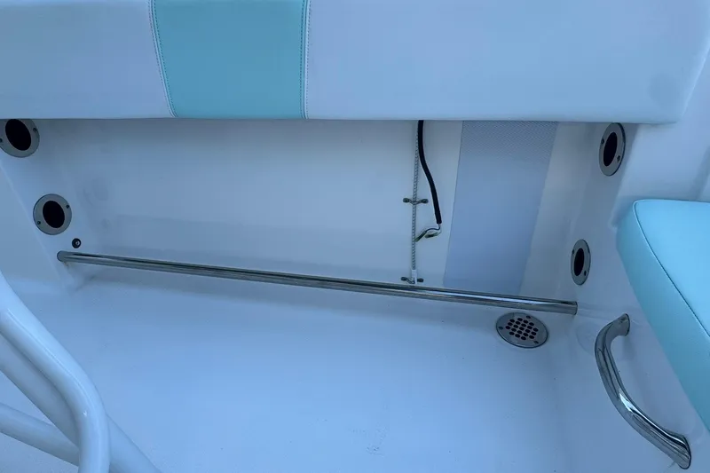 Slide: The Image of 2021 Robalo R200 Center Console interior with stainless steel fittings and light blue accents. - 5