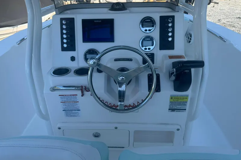 Slide: The Image of 2021 Robalo R200 Center Console boat dashboard with steering wheel and controls. - 9