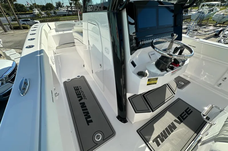Slide: The Image of 2026 Twin Vee 280 GFX2 CC boat interior with steering console and seating area. - 13