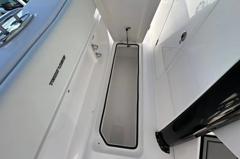 Slide: The Image of 2026 Twin Vee 280 GFX2 CC boat interior storage compartment, sleek design. - 14