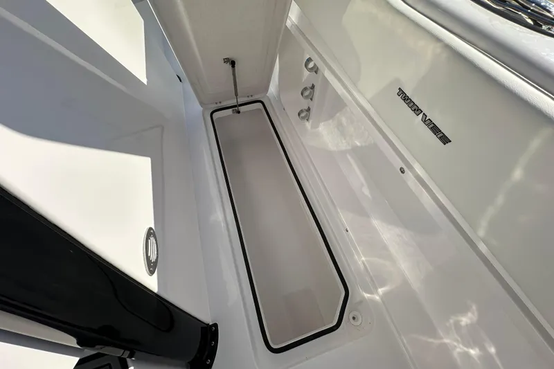 Slide: The Image of 2026 Twin Vee 280 GFX2 CC boat interior with storage compartment and sleek design. - 15